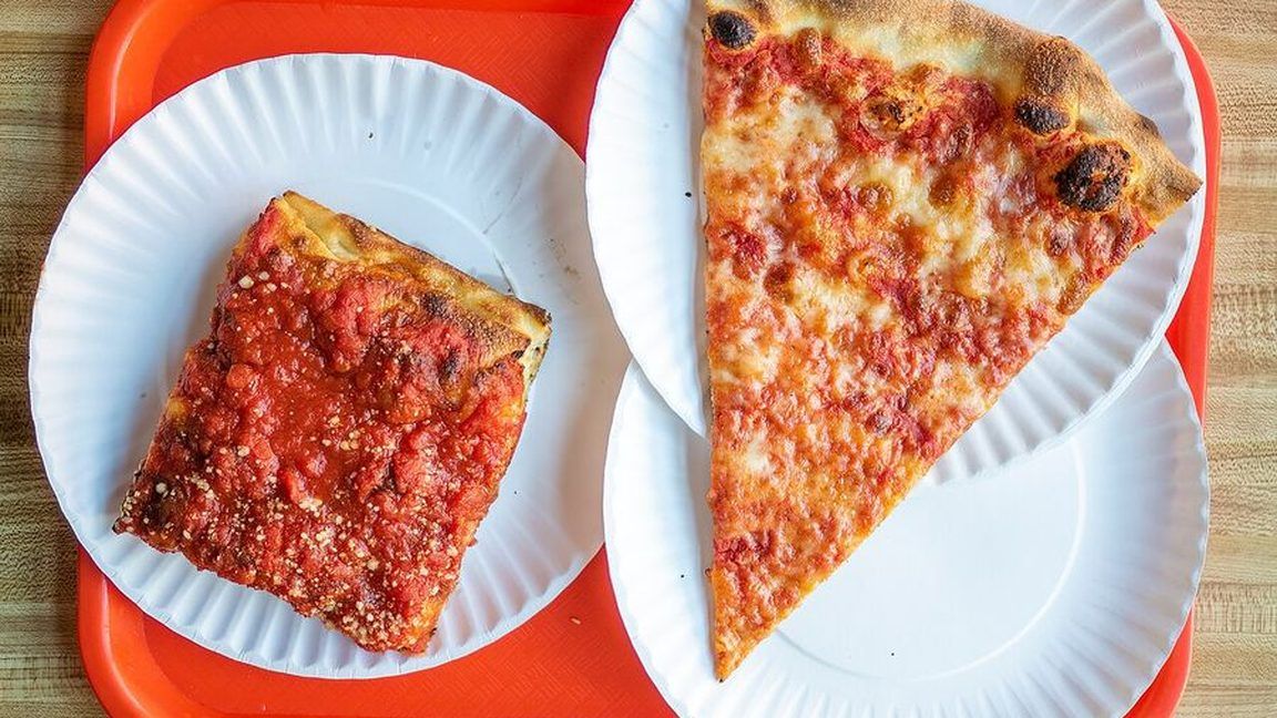 A New York cheese slice and a square slice on paper plates